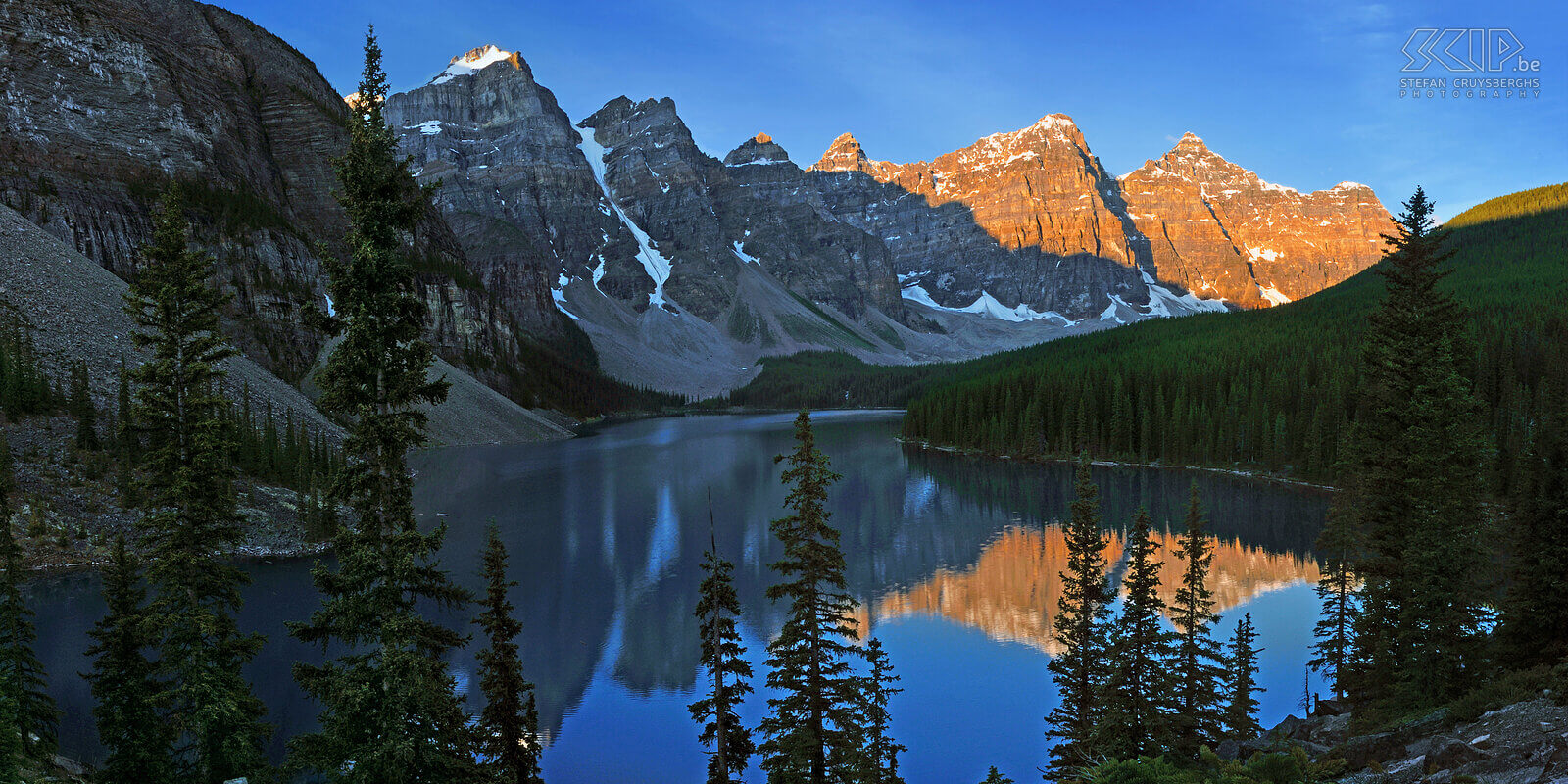 Banff NP - Lake Moraine - Sunrise The first sunlight in the morning results in a wonderful orange glow on the mountains behind the beautiful Lake Moraine. This lake is one of the iconic locations in Banff National Park in the Rocky Mountains in Canada. Stefan Cruysberghs